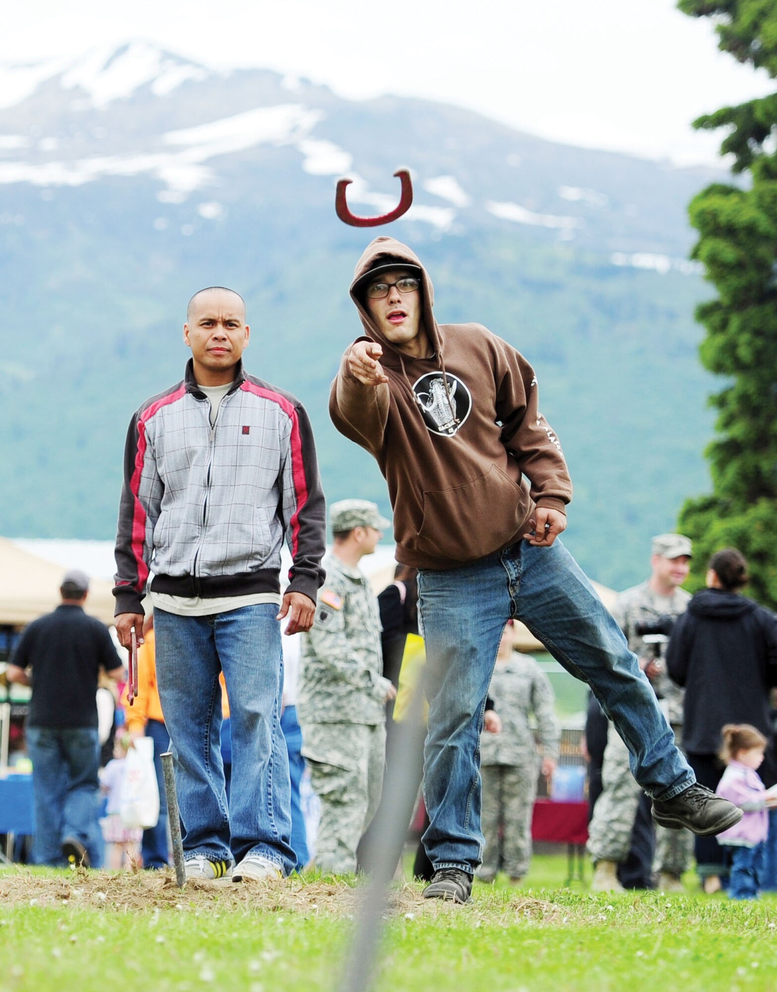 Army Staff Sgt. Erwin Durano, left, and Sgt. Edward Pico, both of the Alaska Army National Guard 207th Combat Support Company, from Anchorage, play horseshoes during the Military Appreciation Day at JBER’s Buckner Physical Fitness Center June
8. (U.S. Air Force/Justin Connaher)