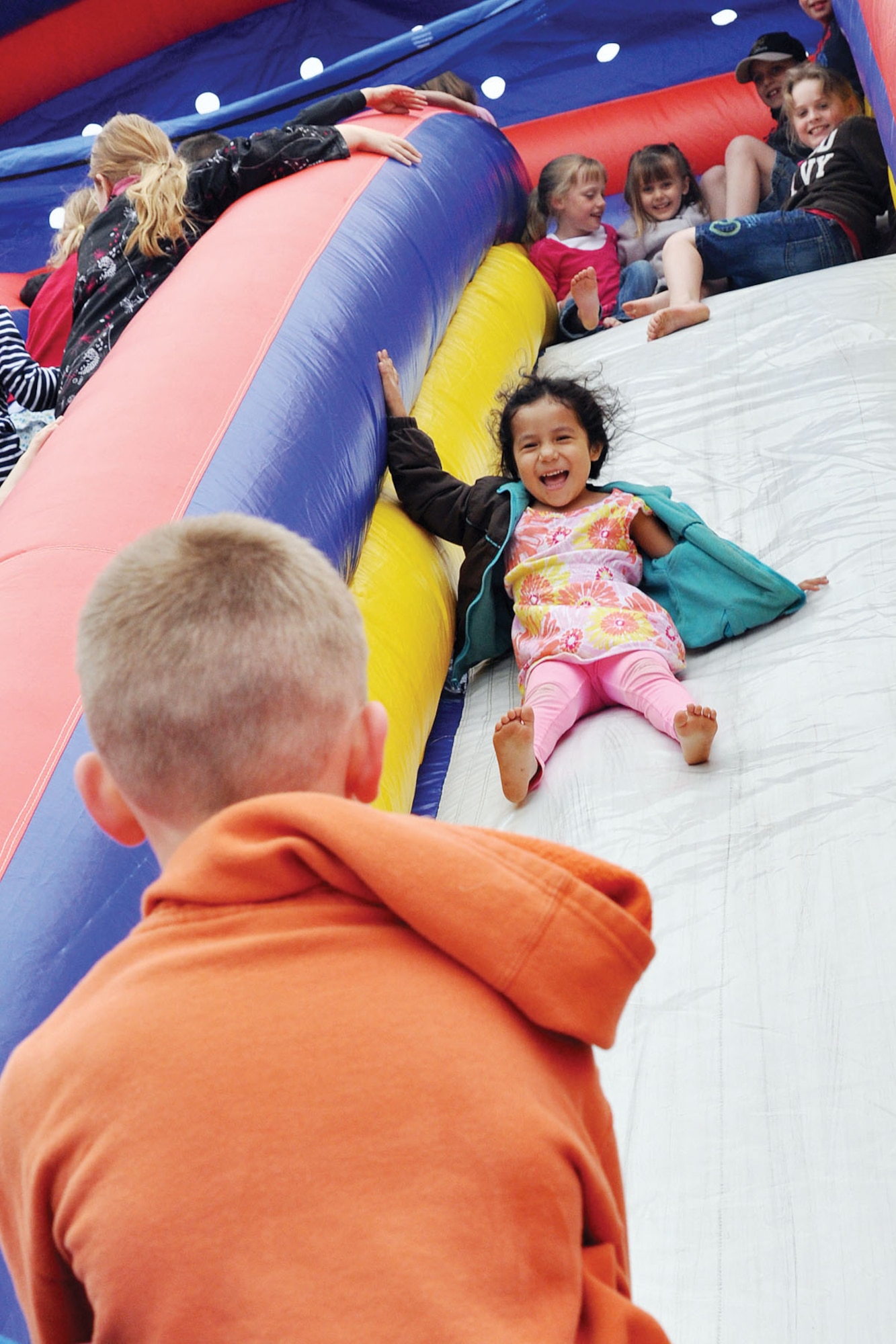 Childern play on the inflatable slide at Buckner Physical Fitness Center June 8 as part of the Anchorage Chamber of Commerce's annual Military Appreciation Picnic. (U.S. Air Force photo/John Pennell)