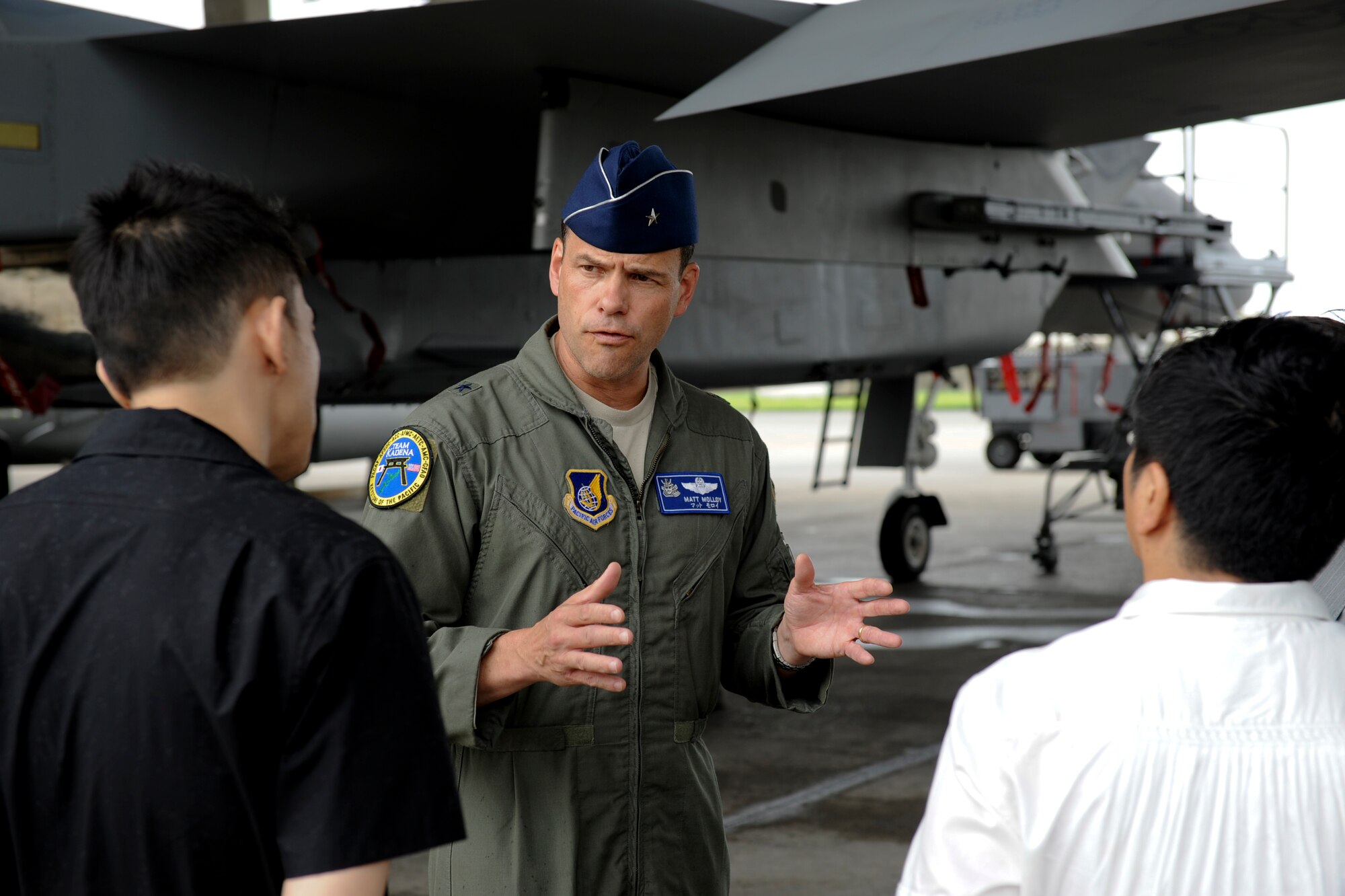 U.S. Air Force Brig. Gen. Matthew Molloy, 18th Wing commander, talks with the Japanese comedy duo known as Bakusho Mondai in front of an F-15 Eagle at Kadena Air Base, Japan, June 1, 2012. Tanaka visited Kadena, with co-host Hikari Ota, to film an episode of a new show, Tanken Bakumon, or 'Deep Inside.' Kadena's segment is scheduled to air on the NHK channel June 20 beginning at 10 p.m. (U.S. Air Force photo/Airman 1st Class Brooke P. Beers)