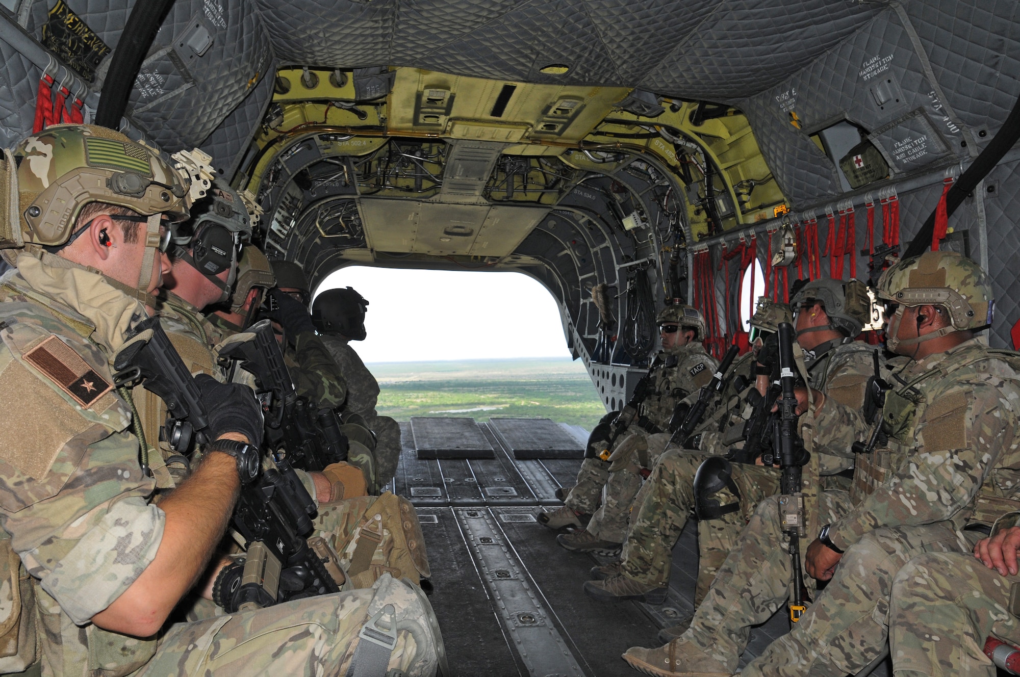 Members of the Texas Air National Guard's 147th Air Support Operations Squadron aboard a Texas Army National Guard CH-47 Chinook helicopter above Yankee Range, the norther of two ranges that comprise the McMullen Target Complex, which is part of Naval Air Station Kingsville, and is managed by Detachment 1, a subcomponent of the Texas Air National Guard's 149th Fighter Wing at Lackland Air Force Base, Texas, on May 30, 2012. (Air National Guard photo by Staff Sgt. Phil Fountain / Released)