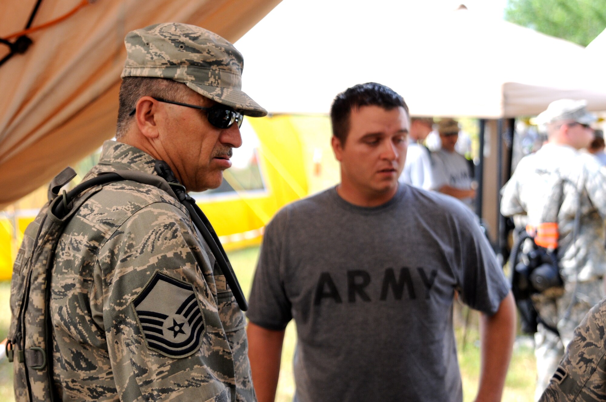 Master Sgt. Frank Rodriguez, a Texas Air National Guard medic assigned to the 6 CBRNE Emergency Response Force Package (CERF-P), a subcomponent of Joint Task Force-71, assists a member of the Texas Army National Guard who is playing to role of a chemical attack victim during an emergency preparedness exercise in Austin, Texas, on Apr. 26, 2012. (Air National Guard photo by Staff Sgt. Phil Fountain / Released)