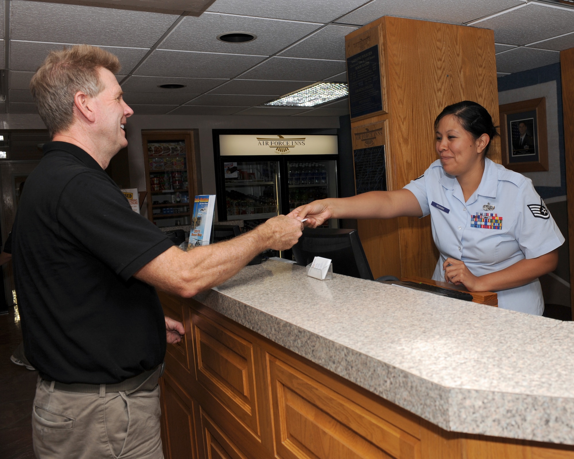 U.S. Air Force Staff Sgt. Clarissa Rosinski, 355th Force Support Squadron front desk representative, helps a customer at the front desk of the Air Force Inn on Davis-Monthan Air Force Base, Ariz., June 12, 2012. As part of Guest Service Operation, the front desk representatives played an important role in the inn being selected as Air Combat Command’s best Lodging Operation. (U.S. Air Force photo by Airman 1st Class Timothy D. Moore/Released)