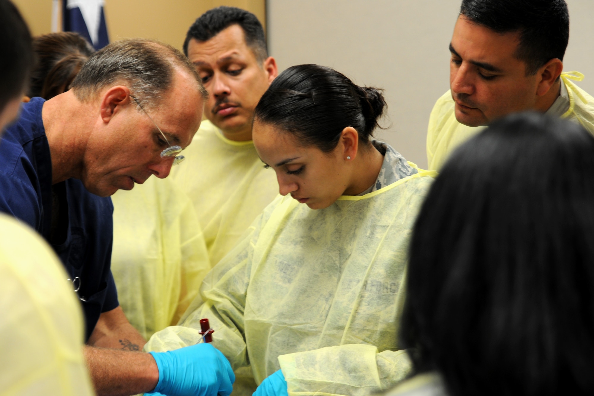 Scotty Bolleter, chief paramedic, demonstrates a medical procedure for members of the Texas Air National Guard's 149th Medical Group, during a training exercise at teh Bulverde Spring Branch Emergency Medical Service (EMS) facility, in Spring Branch, Texas, on Apr. 22, 2012. (Air National Guard photo by Staff Sgt. Phil Fountain / Released)