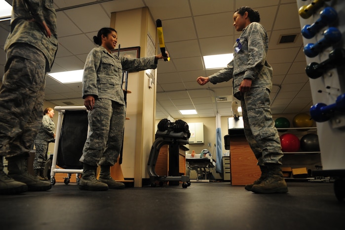 Major Lee Warlick, a physical therapist with the 628th Medical Group, shows Cadet 2nd Class Raika Dacquel, a student with the Air Force Academy, a body blade which is used for various purposes such as shoulder strengthening and core stabilization at the Physical Therapy center on Joint Base Charleston, S.C. June 8, 2012. Cadets visited JB Charleston to get a first-hand look at various career opportunities. (U.S. Air Force photo/Staff Sgt. Katie Gieratz)