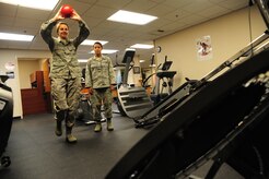 Major Lee Warlick, a physical therapist with the 628th Medical Group, shows Cadet 2nd Class Samantha Laughlin, a student with the Air Force Academy, an exercise using a ball and small trampoline to improve dynamic balance or to re-train a patient’s shoulder at the Physical Therapy center at Joint Base Charleston, S.C., June 8, 2012. Cadets visited JB Charleston to get a first-hand look at various career opportunities. (U.S. Air Force photo/Staff Sgt. Katie Gieratz)