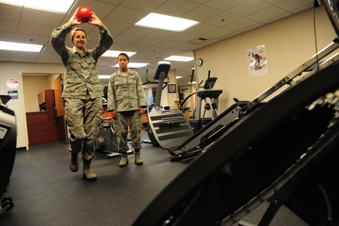 Major Lee Warlick, a physical therapist with the 628th Medical Group, shows Cadet 2nd Class Samantha Laughlin, a student with the Air Force Academy, an exercise using a ball and small trampoline to improve dynamic balance or to re-train a patient’s shoulder at the Physical Therapy center on Joint Base Charleston, S.C. June 8, 2012. Cadets visited JB Charleston to get a first-hand look at various career opportunities. (U.S. Air Force photo/Staff Sgt. Katie Gieratz)