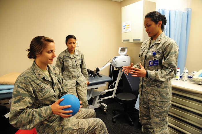 Major Lee Warlick, a physical therapist with the 628th Medical Group, shows Cadet 2nd Class Samantha Laughlin, a student with the Air Force Academy, a core strengthening exercise at the Physical Therapy center on Joint Base Charleston, S.C. June 8, 2012. Cadets visited JB Charleston to get a first-hand look at various career opportunities. (U.S. Air Force photo/Staff Sgt. Katie Gieratz)