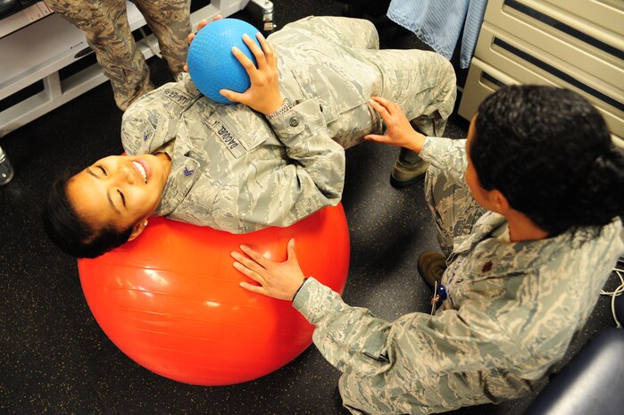 Major Lee Warlick, a physical therapist with the 628th Medical Group, shows Cadet 2nd Class Raika Dacquel, a student with the Air Force Academy, a core strengthening exercise at the Physical Therapy center on Joint Base Charleston, S.C. June 8, 2012. Cadets visited JB Charleston to get a first-hand look at various career opportunities. (U.S. Air Force photo/Staff Sgt. Katie Gieratz)