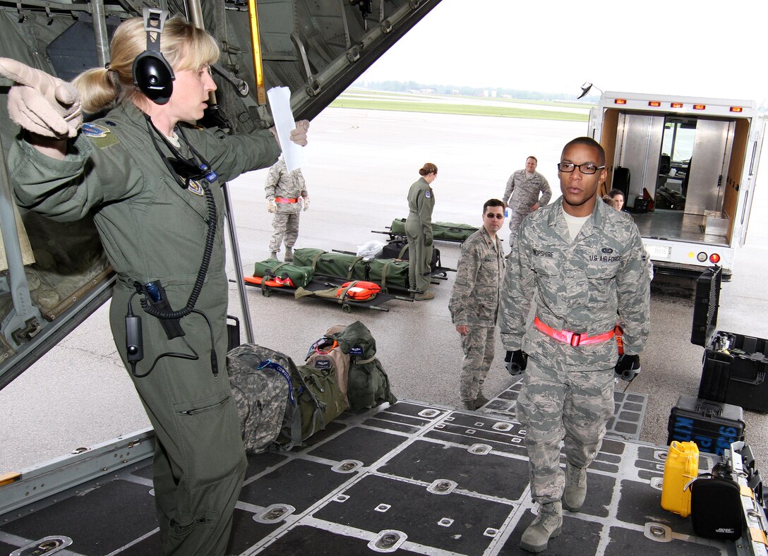 Lt. Col. Shelby Mills, 932nd  Aeromedical Evacuation Squadron flight nurse, directs members of the 932nd Aeromedical Staging Squadron performing patient loading on a C-130 during a field training exercise at Scott Air Force Base.   The training included moving patient litters from an aeromedical staging area onto ambulances and then to the flightline.  (U.S. Air Force photo/Tech. Sgt. Christopher Parr)