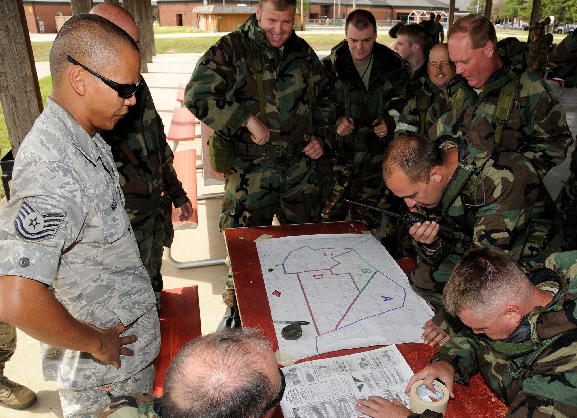 Tech Sgt. Robby McGee with the 188th Emergency Management Flight teaches Post Attack Recon (PAR) procedures to Airmen with the 188th Fighter Wing during a Chemical, Biological, Radiological, Nuclear and High Yield Explosives (CBRNE) class at the 188th June 7, 2012. The PAR training includes unexploded ordnance recognition and marking, map reading and the communications process back to the unit control centers. The 188th Airmen are gearing up for an Air Expeditionary Forces deployment to Afghanistan later this summer. (National Guard photo by Airman 1st Class Hannah Landeros/188th Fighter Wing Public Affairs) 