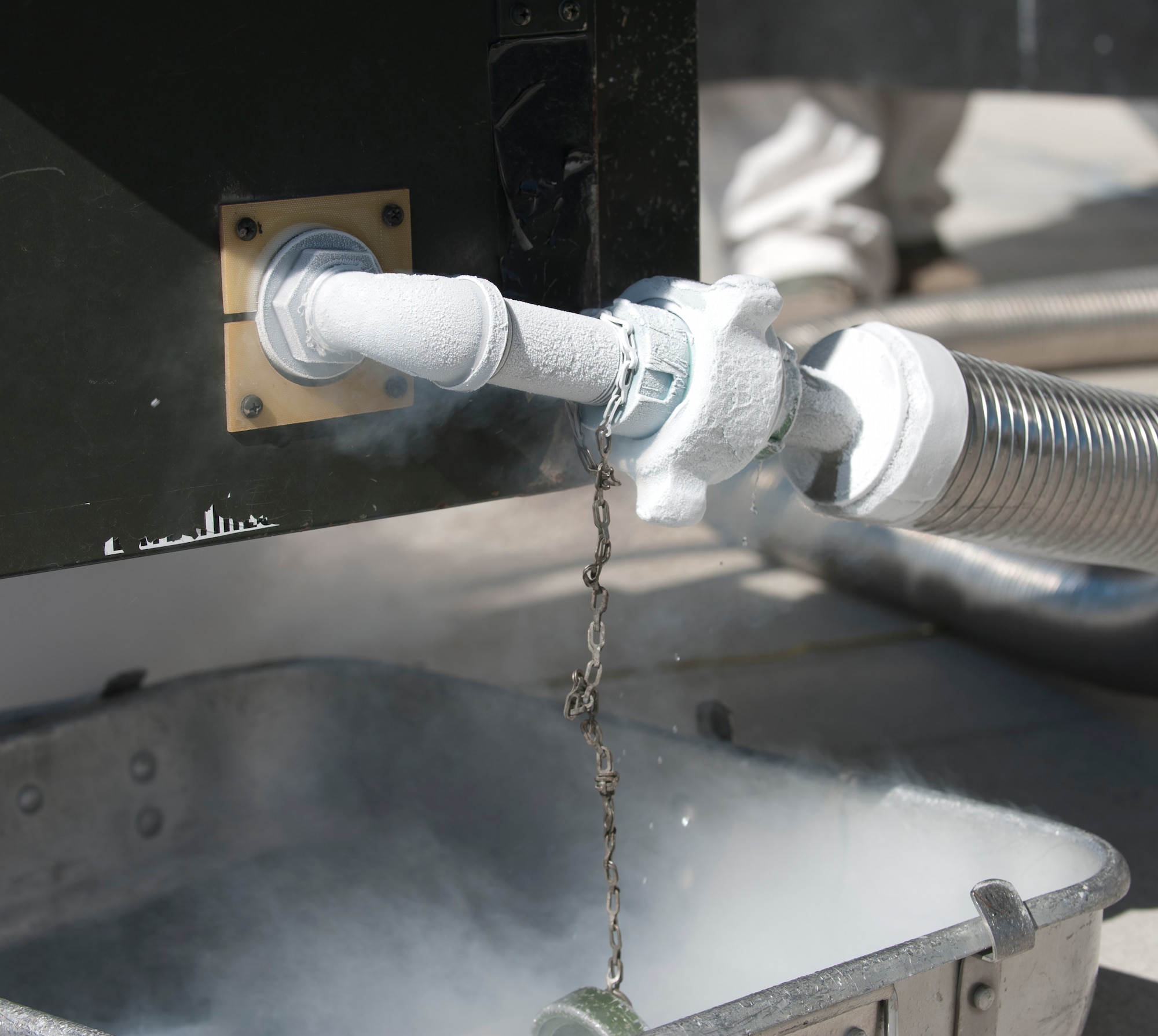 Droplets of liquid oxygen drip out of a hose attached to the LOX cart. The oxygen is approximately -500 degrees Ferinheight when in LOX tanks and boils to -297 degrees Ferinheight when it escapes the hose making it become a gas giving it its foggy apperance. (U.S. Air Force photo/Airman 1st Class Nicole Leidholm)