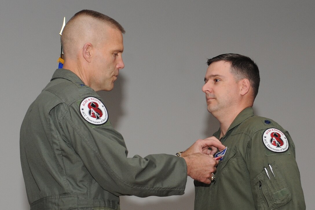 U.S. Air Force Lt. Col. James Merchant, Air Combat Command deputy chief of the irregular warfare division, receives the Bronze Star Medal from Maj. Gen. Steven Kwast, ACC director of requirements, during an awards ceremony at Langley Air Force Base, Va., June 13, 2012. Merchant distinguished himself while engaged in ground operations against an opposing armed force, expertly leading 665 personnel across nine squadrons at four locations throughout Afghanistan, in support of Operation Enduring Freedom. The operations group, under Merchant’s guidance, generated 20,938 combat sorties and 145,390 hours of close air support, intelligence, surveillance and reconnaissance, tactical airlift, personnel recovery, casualty evacuation, and airborne command and control, in nearly six months. (U.S. Air Force photo by Airman 1st Class Racheal Watson/Released)
