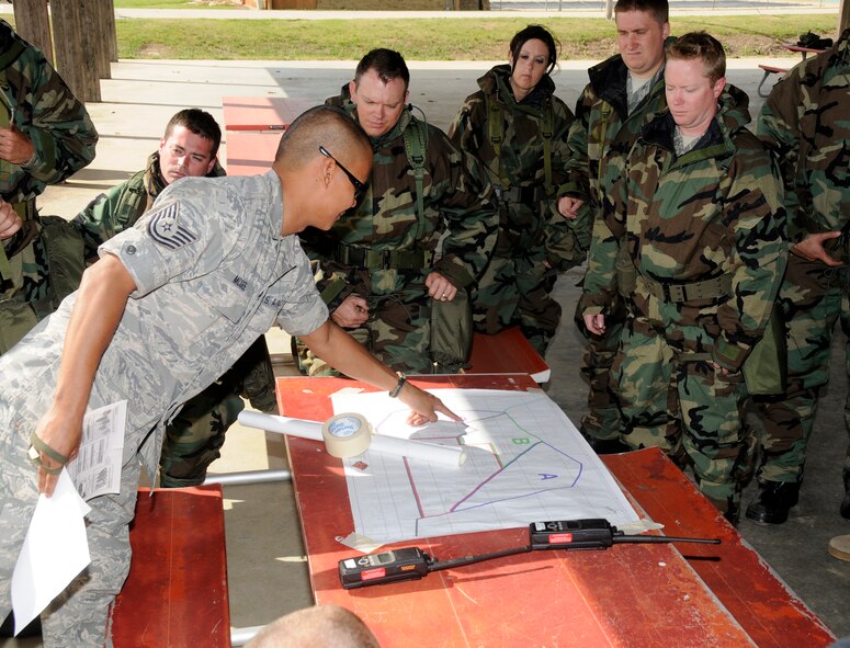 Tech Sgt. Robby McGee with the 188th Emergency Management Flight teaches Post Attack Recon (PAR) procedures to Airmen with the 188th Fighter Wing during a Chemical, Biological, Radiological, Nuclear and High Yield Explosives (CBRNE) class at the 188th June 7, 2012. The PAR training includes unexploded ordnance recognition and marking, map reading and the communications process back to the unit control centers. The 188th Airmen are gearing up for an Air Expeditionary Forces deployment to Afghanistan later this summer. (National Guard photo by Airman 1st Class Hannah Landeros/188th Fighter Wing Public Affairs) 