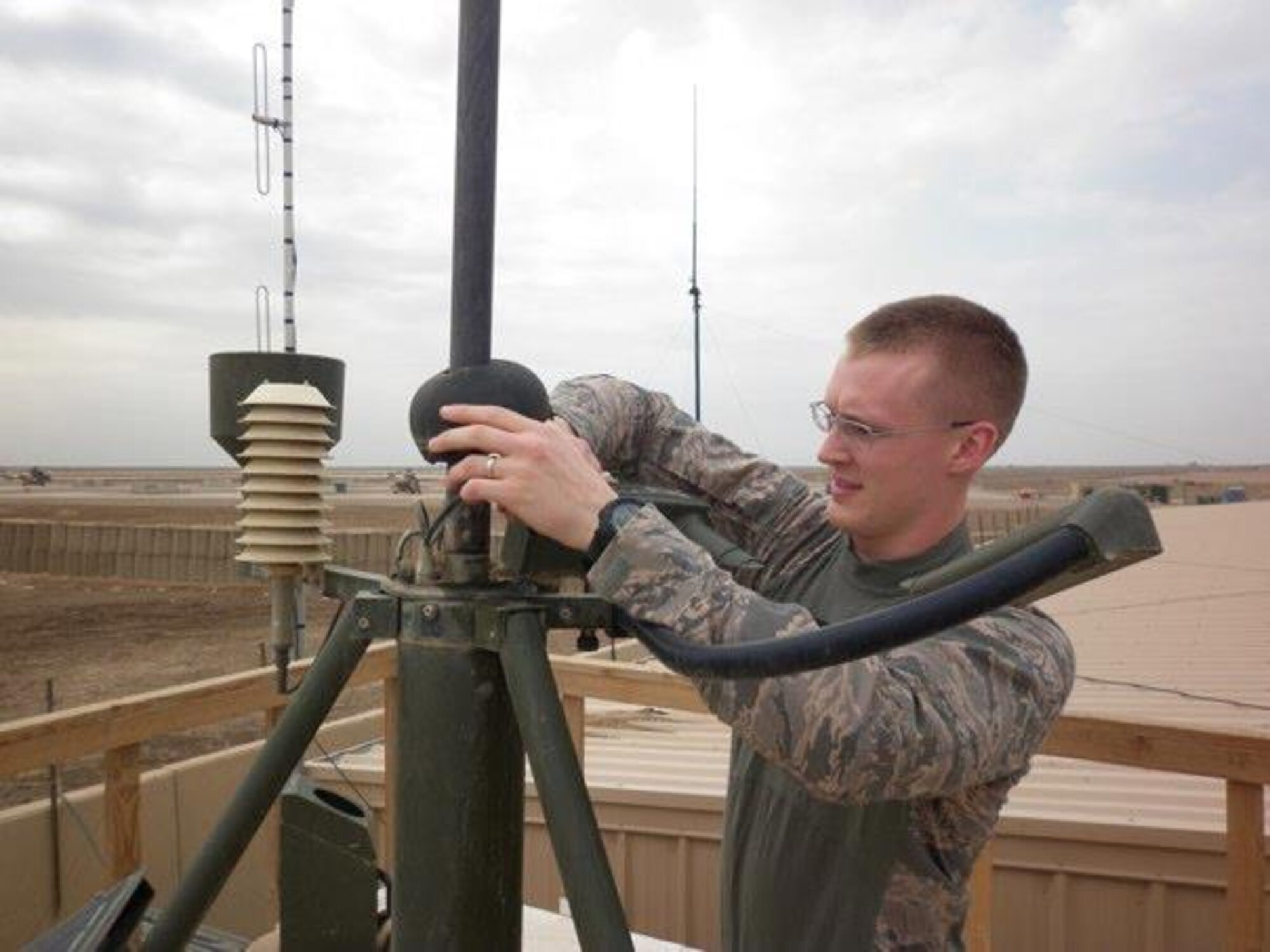 Air Force District of Washington weather forecaster Senior Airmen Matthew Butler connects cables for a weather sensor while deployed to a Forward Operating Base in Iraq.  Butler was selected as one of 12 of the Air Force 2012 Outstanding Airmen of the Year. He is currently stationed at Scott Air Force Base, Ill., with the 15th Operational Weather Squadron, an element under AFDW. (Courtesy Photo) 