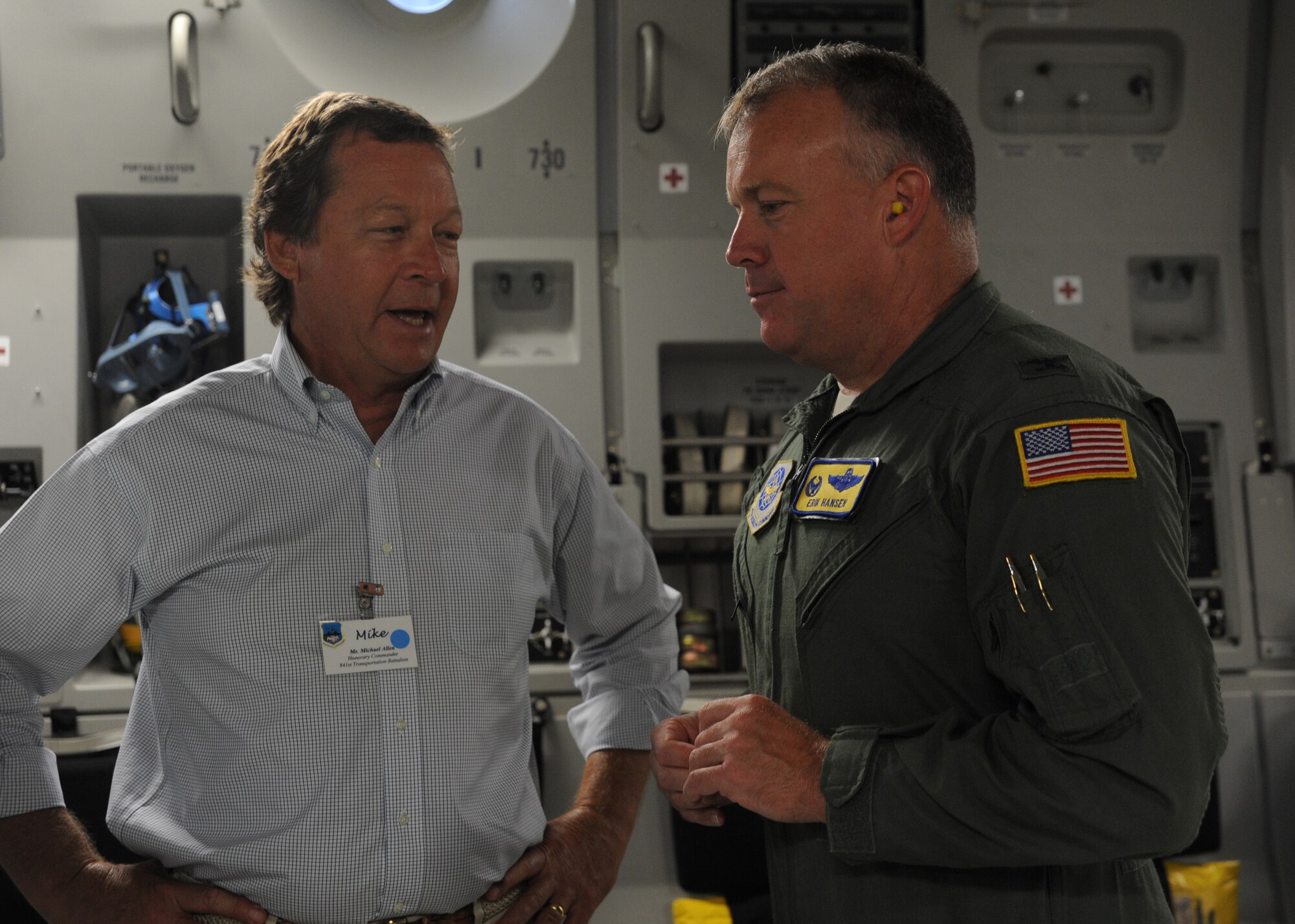 Colonel Erik Hansen, 437th Airlift Wing commander out of Joint Base Charleston, S.C., speaks with Team Charleston honorary commander Michael Allen, president and chief engineer of Coastal Engineering & Testing Company, aboard a C-17 Globemaster III with Team Charleston honorary commanders during an orientation flight June 12, 2012. The honorary commanders program is used as a tool to educate local community leaders about the various missions at JB Charleston. The tours will take place on a quarterly basis, and as part of that education process, the 437th AW set aside a full day to give the civics an in-depth look at the wing's flying mission. It afforded them the opportunity to meet the Airmen, both maintainers and operators, who support the mission. (U.S. Air Force photo/Airman 1st Class Ashlee Galloway)