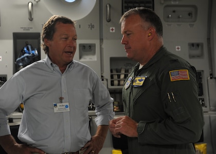 Colonel Erik Hansen, 437th Airlift Wing commander out of Joint Base Charleston, S.C., speaks with Team Charleston honorary commander Michael Allen, president and chief engineer of Coastal Engineering & Testing Company, aboard a C-17 Globemaster III with Team Charleston honorary commanders during an orientation flight June 12, 2012. The honorary commanders program is used as a tool to educate local community leaders about the various missions at JB Charleston. The tours will take place on a quarterly basis, and as part of that education process, the 437th AW set aside a full day to give the civics an in-depth look at the wing's flying mission. It afforded them the opportunity to meet the Airmen, both maintainers and operators, who support the mission. (U.S. Air Force photo/Airman 1st Class Ashlee Galloway)
