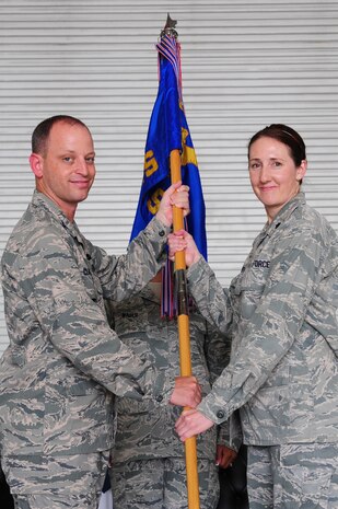 Colonel James Clavenna, 437th Maintenance Group commander, takes the squadron guidon from Maj. Jeffrey Darden, 437th Maintenance Squadron outgoing commander, during the 437th MXS change of command ceremony at Joint Base Charleston - Air Base, S.C, June 11, 2012. The handing over of the guidon symbolizes the changing of a command. (U.S. Air Force photo/ Airman 1st Class Chacarra Walker)
