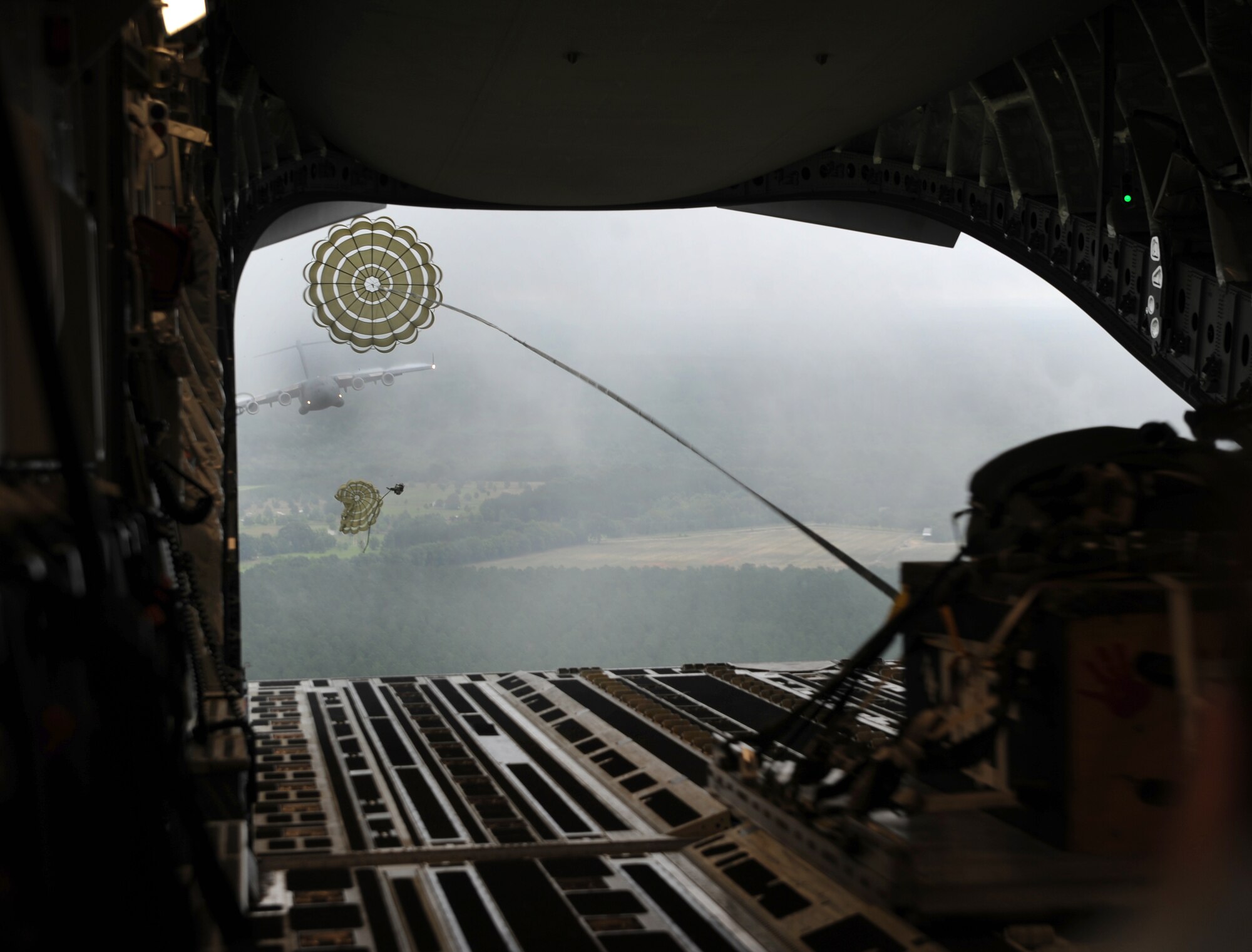 During a C-17 Globemaster III orientation flight for the Team Charleston honorary commanders, out of Joint Base Charleston, S.C., airmen demonstrate a low-level air drop, to show the capabilities that JB Charleston has to offer June 12, 2012. The honorary commanders program is used as a tool to educate local community leaders about the various missions at JB Charleston. The tours will take place on a quarterly basis, and as part of that education process, the 437th AW set aside a full day to give the civics an in-depth look at the wing's flying mission. It afforded them the opportunity to meet the Airmen, both maintainers and operators, who support the mission. (U.S. Air Force photo/Airman 1st Class Ashlee Galloway)
