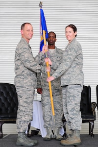 Colonel James Clavenna, 437th Maintenance Group commander, takes the squadron guidon from Lt. Col. Tracey Smith, 437th Maintenance Operations Squadron outgoing commander, during the 437th MOS change of command ceremony at Joint Base Charleston - Air Base, S.C, June 11, 2012. The handing over of the guidon symbolizes the changing of a command. (U.S. Air Force photo/ Airman 1st Class Chacarra Walker)