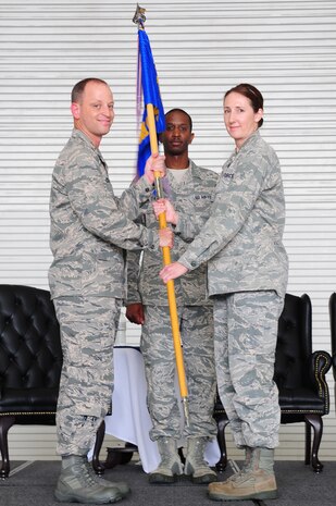 Colonel James Clavenna, 437th Maintenance Group commander, takes the squadron guidon from Lt. Col. Tracey Smith, 437th Maintenance Operations Squadron outgoing commander, during the 437th MOS change of command ceremony at Joint Base Charleston - Air Base, S.C, June 11, 2012. The handing over of the guidon symbolizes the changing of a command. (U.S. Air Force photo/ Airman 1st Class Chacarra Walker)