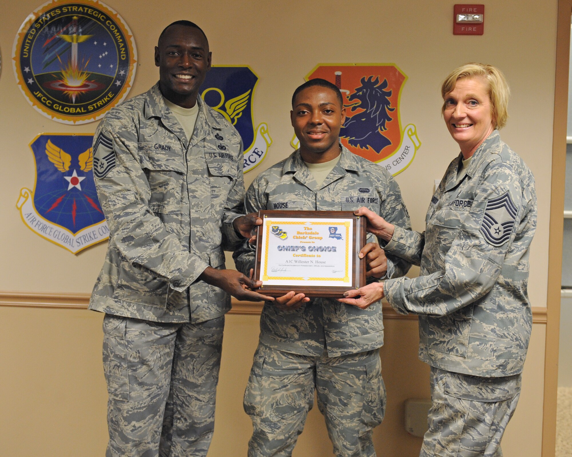 Members of the Chief's Group present Airman 1st Class Willester House, 608th Air Communications Squadron, with a Chief's Choice certificate on Barksdale Air Force Base, La., June 13. The Chief's Choice award is given out to Airmen in the rank of technical sergeant and below who exemplify the Air Force core values. (U.S. Air Force photo/Airman 1st Class Benjamin Gonsier)(RELEASED)

