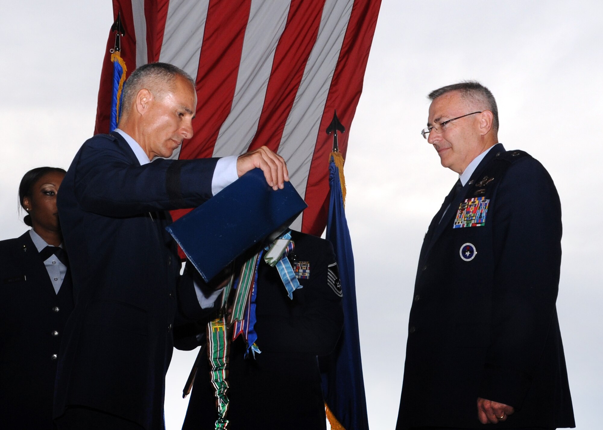ALTUS AIR FORCE BASE, Okla. – Brig. Gen. Udo K. “Karl” McGregor, commander of the 452nd Air Mobility Wing, March Air Reserve Base, Calif., unsheathes a new 730th Air Mobility Training Squadron flag during the squadron reactivation and assumption of command, while Lt. Col.  Jonathan M. Philebaum, 730th AMTS commander, Altus AFB, waits to assume command of the squadron at hangar 517 June 13, 2012. The 730th AMTS falls under the 452nd Air Mobility Wing at March ARB and is part of the Air Force Reserve Command. (U.S. Air Force photo by Airman 1st Class Franklin R. Ramos / 97th Air Mobility Wing / Released)