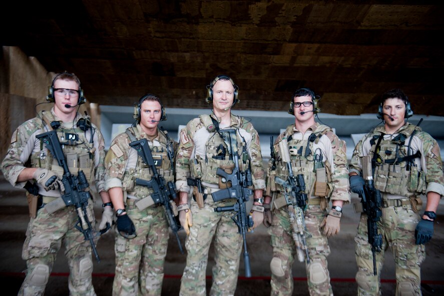 U.S. Air Force Col. Bill Thompson, 23d Wing commander, middle, poses for a photo with, from left to right, Senior Airman Brandon Smith, Staff Sgt. Eric Braddock, Capt. Daniel Catino and Staff Sgt.  Alejandro Serrano during combat arms training June 12, 2012, at Moody Air Force Base, Ga. The 38th Rescue Squadron pararescuemen and combat rescue officer invited Thompson to join them during training to give him a better understanding of what they do to remain proficient at their jobs. (U.S. Air Force photo by Staff Sgt. Jamal D. Sutter/Released) 