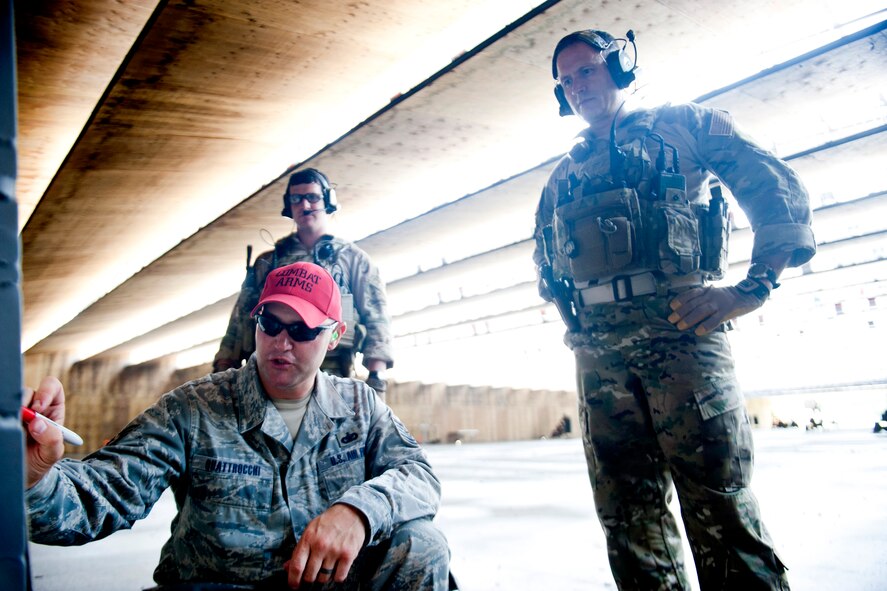 U.S. Air Force Tech. Sgt. Russell Quattrocchi, 38th Rescue Squadron combat arms training and maintenance instructor, discusses target marks with Col. Bill Thompson, 23d Wing commander, during combat arms training June 12, 2012, at Moody Air Force Base, Ga. Before being assigned to the 38th RQS, Quattrocchi served as an instructor for the 23d Security Forces Squadron and 820th Combat Operations Squadron. (U.S. Air Force photo by Staff Sgt. Jamal D. Sutter/Released) 