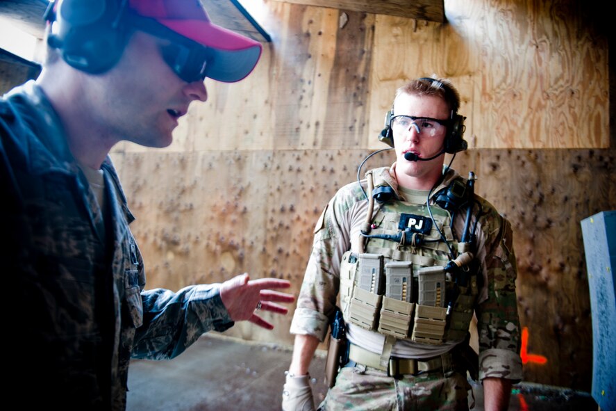 U.S. Air Force Staff Sgt. David Deel, 38th Rescue Squadron combat arms training and maintenance instructor, discusses firing adjustments with Senior Airman Brandon Smith, 38th RQS pararescueman, during combat arms training June 12, 2012, at Moody Air Force Base, Ga. The 38th RQS trains, equips and employs combat-ready PJs and supporting Airmen in support of U.S. rescue operations. (U.S. Air Force photo by Staff Sgt. Jamal D. Sutter/Released)  