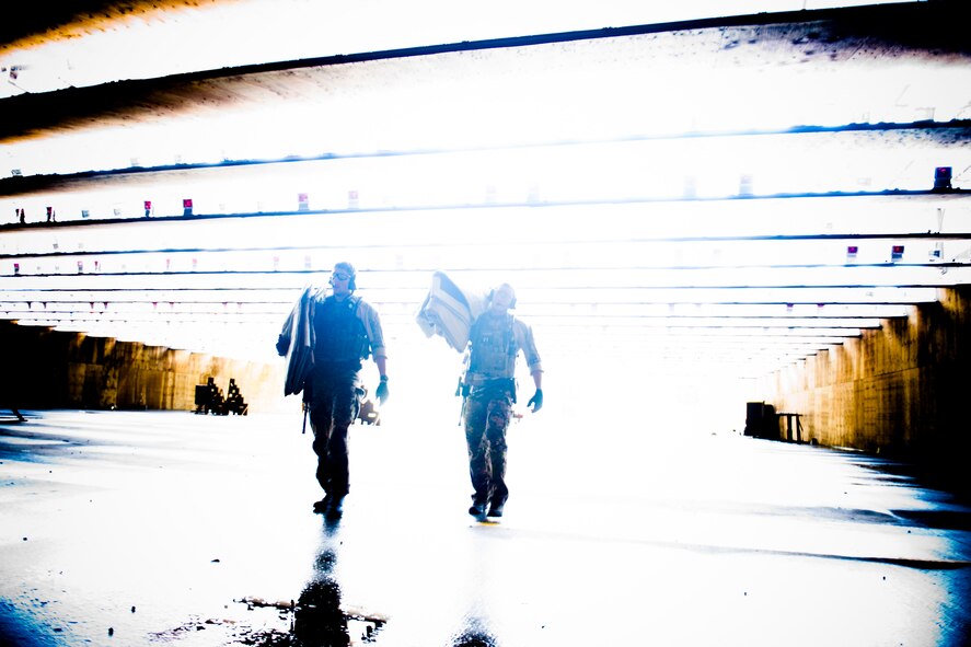 U.S. Air Force Staff Sgts. Alejandro Serrano and Eric Braddock, 38th Rescue Squadron pararescuemen, make their way to their firing posts during combat arms training June 12, 2012, at Moody Air Force Base, Ga. The PJs trained with the M4 assault rifle and M9 pistol to stay current on their tactics, techniques and procedures. (U.S. Air Force photo by Staff Sgt. Jamal D. Sutter/Released) 