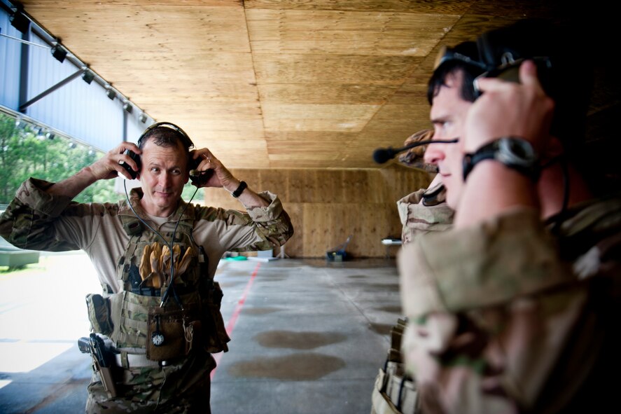 U.S. Air Force Col. Billy Thompson, 23d Wing commander, and Capt. Daniel Catino, 38th Rescue Squadron combat rescue officer, prepare their equipment before combat arms training June 12, 2012, at Moody Air Force Base, Ga. Thompson trained with the 38th RQS to become more familiar with their combat tactics, techniques and procedures. (U.S. Air Force photo by Staff Sgt. Jamal D. Sutter/Released) 