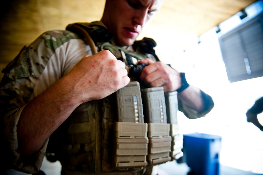 U.S. Air Force Senior Airman Brandon Smith, 38th Rescue Squadron pararescueman, secures his equipment before combat arms training June 12, 2012, at Moody Air Force Base, Ga. Smith and three other 38th RQS Airmen spent nearly three hours training to remain familiar with their weapons and various combat techniques. (U.S. Air Force photo by Staff Sgt. Jamal D. Sutter/Released) 