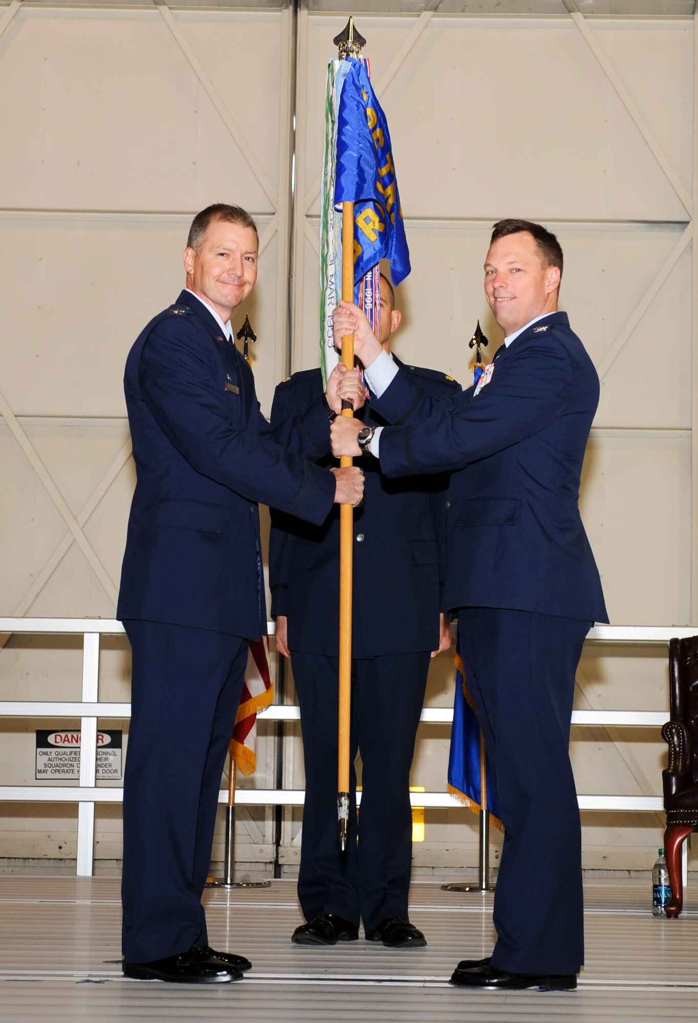 Col. William Thomas, 336th Training Group commander, hands the 36th Rescue Flight’s guidon to Col. Dagvin Anderson, 58th Operations Group commander, during the unit’s transfer of authority ceremony at Fairchild Air Force Base, Wash., June 6, 2012. The 36th RQF transferred from the 336th TRG to the 58th SOG at Kirtland Air Force Base, N.M. Transfer of authority ceremonies represent a formal transfer of responsibility from one command or commander to the next. (U.S. Air Force photo by Senior Airman Benjamin Stratton/Released)
