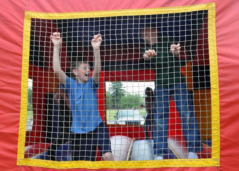 Children jump inside a Bouncy Castle during the quarterly Deployed Families Dinner June 11, 2012, at the McChord Field Chapel Support Center on Joint Base Lewis-McChord, Wash. (U.S. Air Force photo/Senior Airman Leah Young)