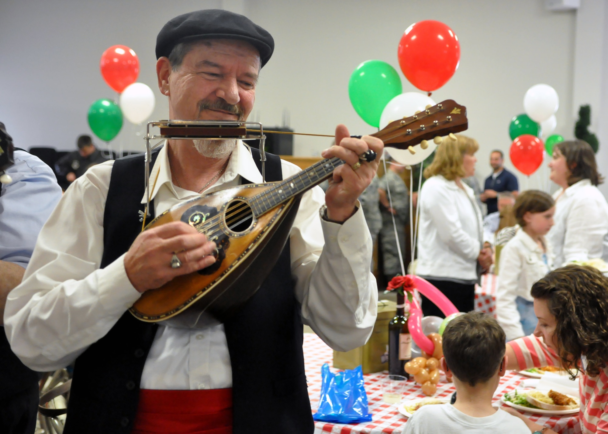 An instrumentalist provides music to coincide with the ‘Mangia Italiana’ themed Deployed Families Dinner June 11, 2012, at the McChord Field Chapel Support Center on Joint Base Lewis-McChord, Wash. More than 140 people attended the event, to include spouses, family members and servicemembers. (U.S. Air Force photo/Senior Airman Leah Young)