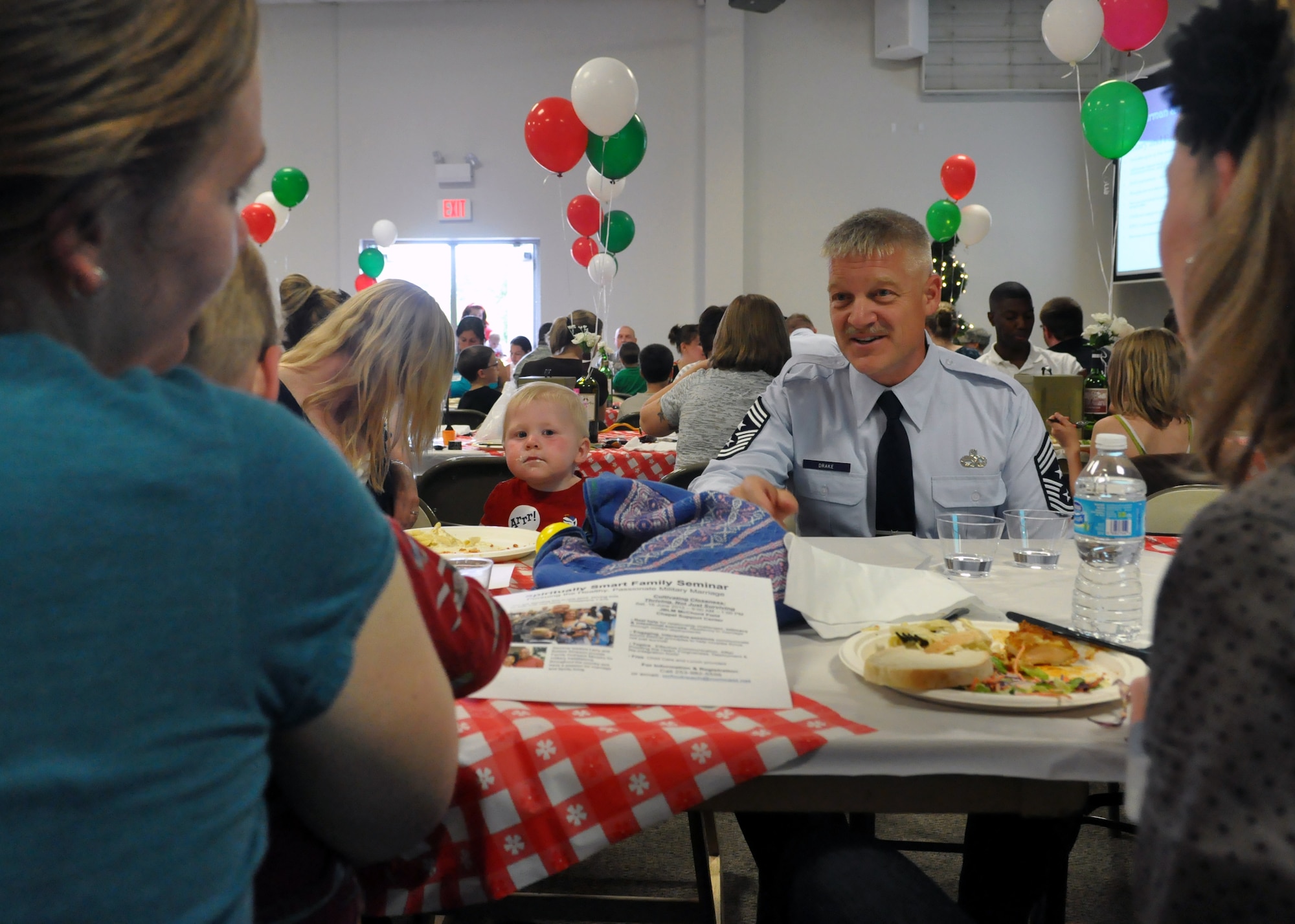 Chief Master Sgt. Gordon Drake, 62nd Airlift Wing command chief, speaks to a group of spouses at the quarterly Deployed Families Dinner June 11, 2012, at the McChord Field Chapel Support Center on Joint Base Lewis-McChord, Wash. Drake expressed his appreciation for hard-working spouses and emphasized the importance of a strong family. (U.S. Air Force photo/Senior Airman Leah Young)