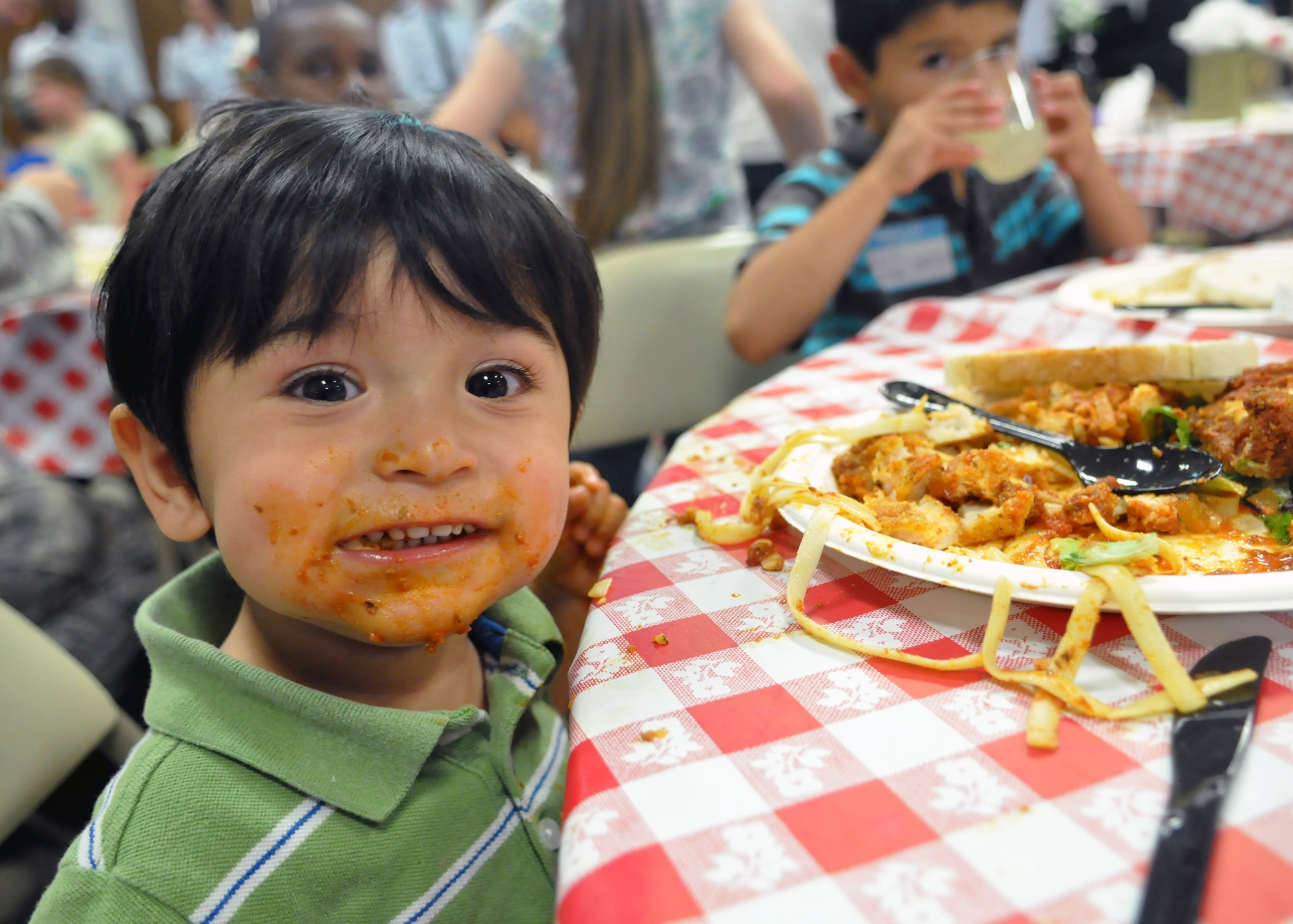 Adrian Vilca, son of Staff Sgts. Eddson and Katherine Vilca, enjoys a spaghetti dinner June 11, 2012, at the McChord Field Chapel Support Center on Joint Base Lewis-McChord, Wash. The family was attending the quarterly Deployed Families Dinner, which provides support to families who are currently coping with a deployment of a loved one. (U.S. Air Force photo/Senior Airman Leah Young)