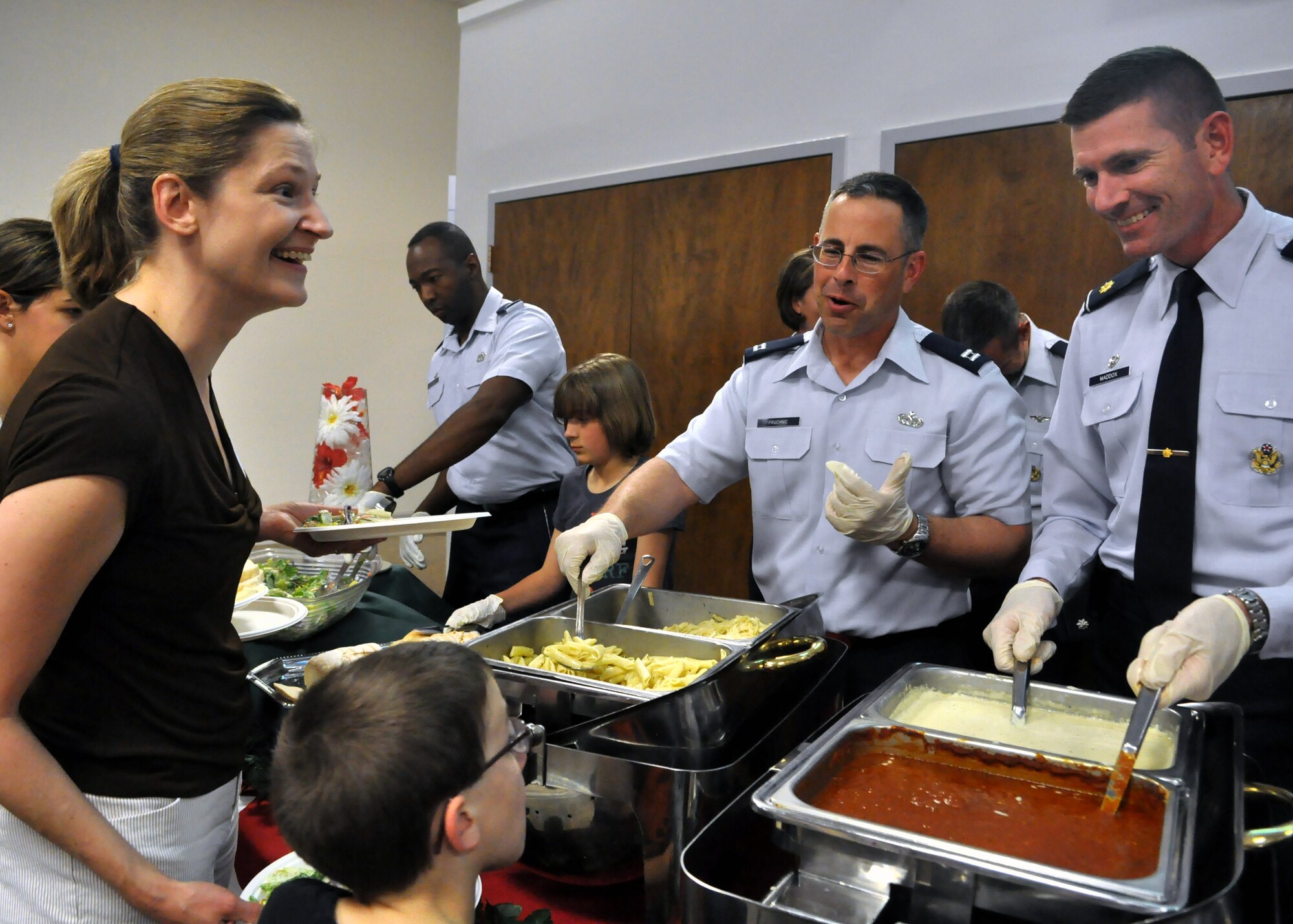 McChord Field leaders serve food at the quarterly Deployed Families Dinner June 11, 2012, at the McChord Field Chapel Support Center on Joint Base Lewis-McChord, Wash. The event, which includes face painting, a meal and more, is held to support families who are currently coping with a deployment of a loved one. (U.S. Air Force photo/Senior Airman Leah Young)