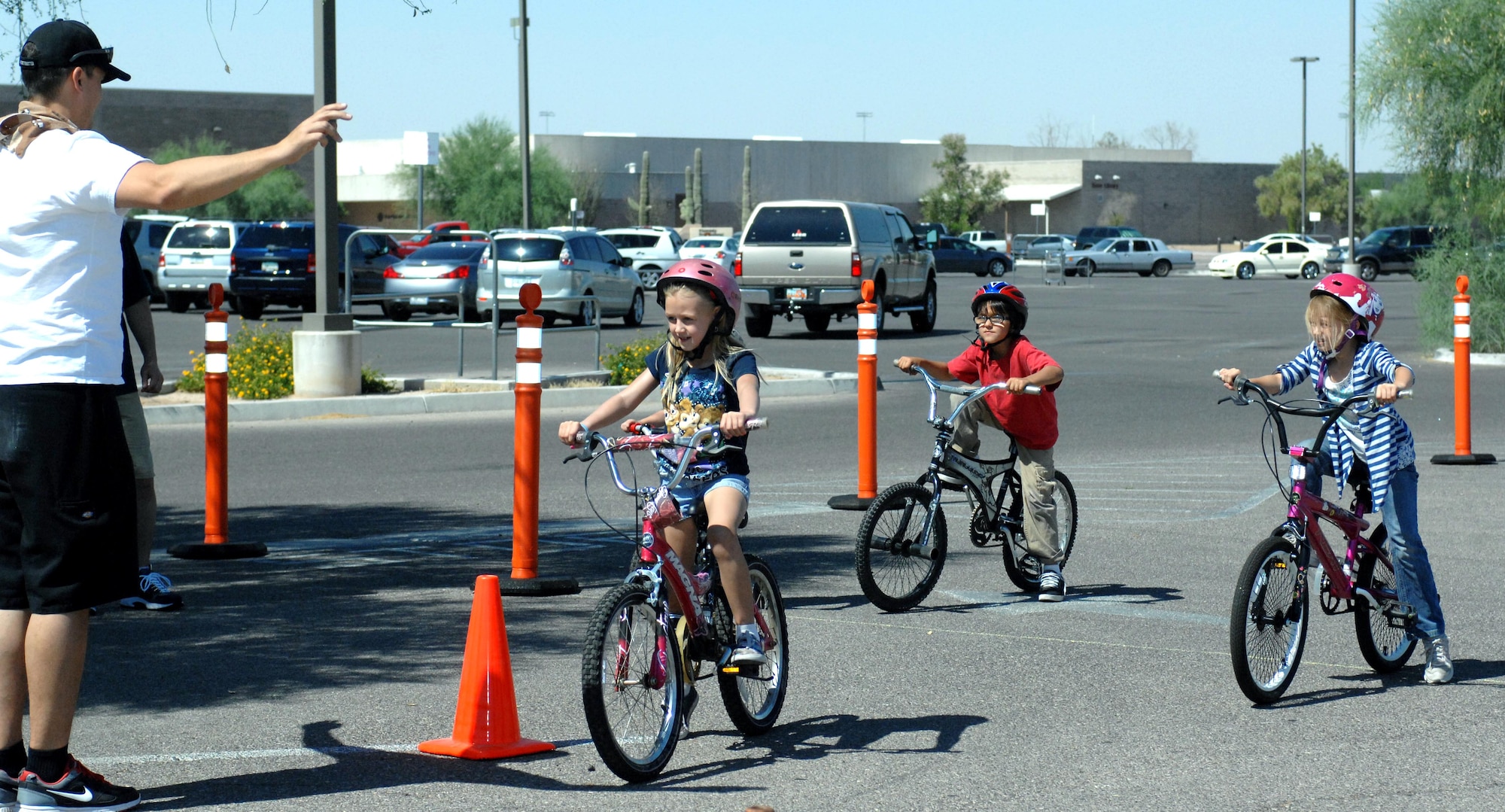 U.S. Air Force Tech. Sgt. Joseph Haber counts down to the start of the bicycle drag race at the Bicycle Rodeo held in the Base Exchange parking lot on Davis-Monthan Air Force Base, Ariz., June 9, 2012. The rodeo also featured a bike safety briefing, an obstacle course and bicycle bingo. (U.S. Air Force photo by Airman 1st Class Saphfire Cook/Released)