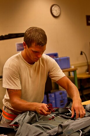 Senior Airman Benjamin Leis, an aircrew flight equipment technician with the 437th Operations Support Squadron out of Joint Base Charleston - Air Base, S.C., prepares a parachute to be packed for a C-17A Globemaster III, June 8, 2012. The Airmen swap out and inspect equipment for C-17A alert aircraft on standby every 30 days. (U.S. Air Force photo by Airman 1st Class George Goslin/Released)