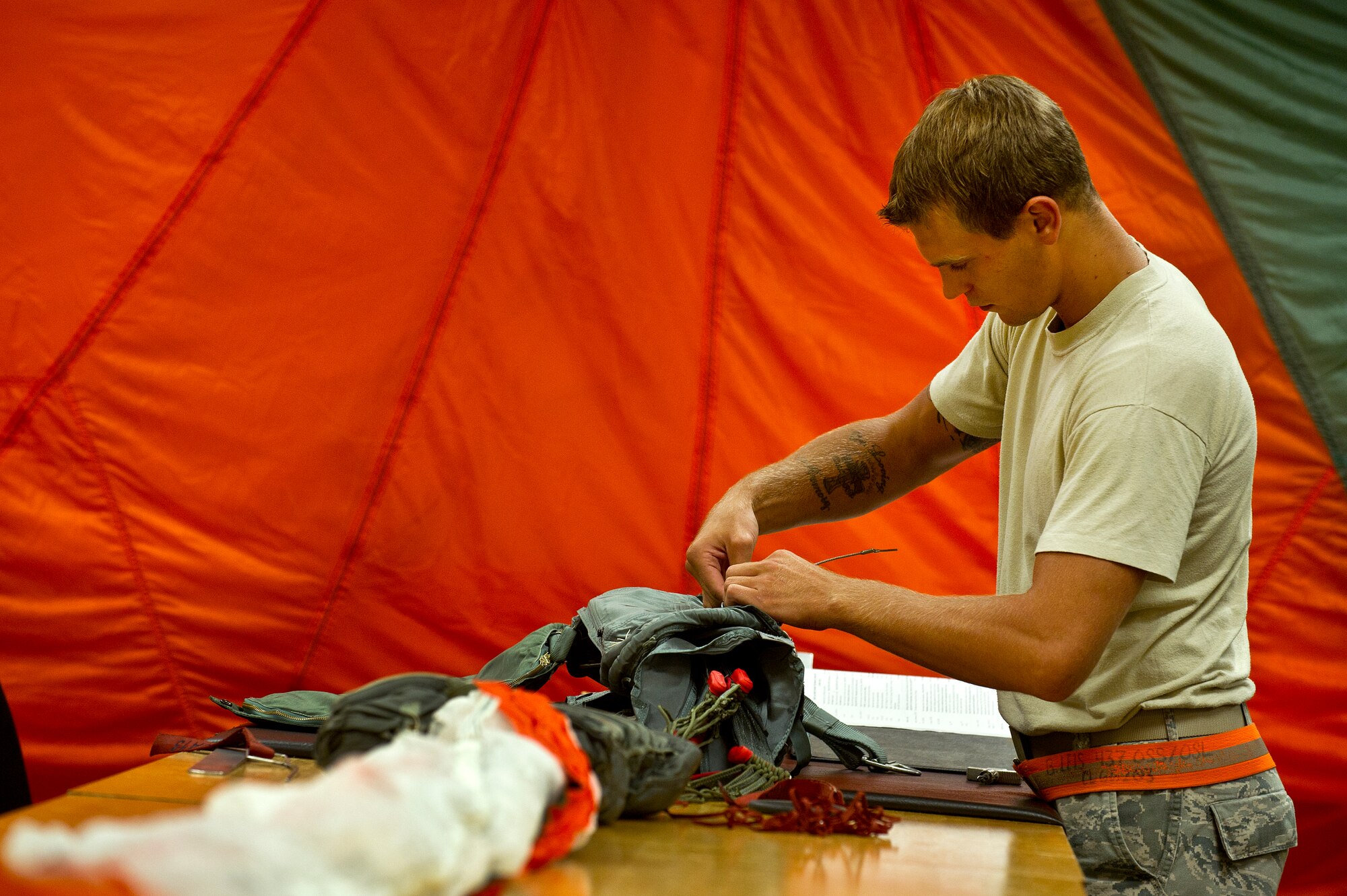 Senior Airman Benjamin Leis, an aircrew flight equipment technician with the 437th Operations Support Squadron out of Joint Base Charleston - Air Base, S.C., prepares a parachute to be packed for a C-17A Globemaster III, June 8, 2012. The Airmen swap out and inspect equipment for C-17A alert aircraft on standby every 30 days. (U.S. Air Force photo by Airman 1st Class George Goslin/Released)