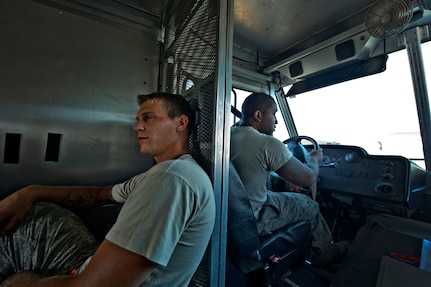 Senior Airman Benjamin Leis and Staff Sgt. Ralph Miller, aircrew flight equipment technicians with the 437th Operations Support Squadron out of Joint Base Charleston - Airbase, S.C., prepare to ride out to the flightline, June 8, 2012. The Airmen swap out and inspect equipment for C-17A alert aircraft on standby every 30 days. (U.S. Air Force photo by Airman 1st Class George Goslin/Released)