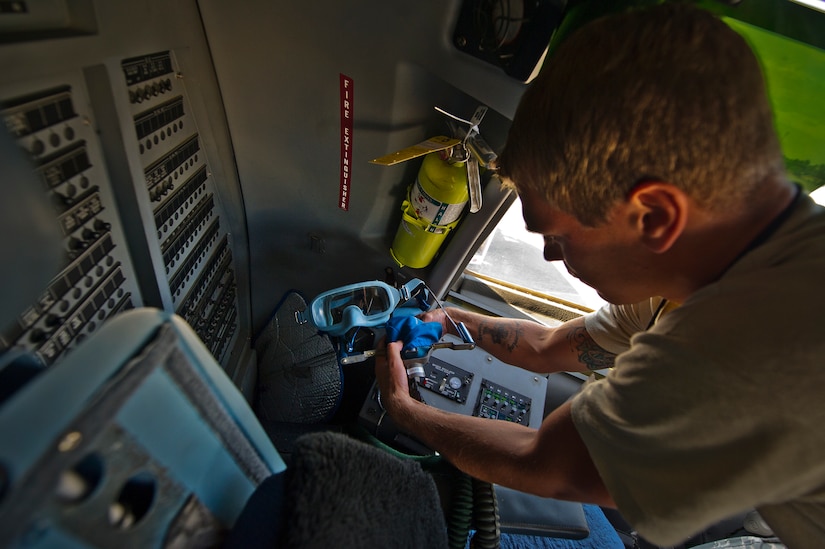 Senior Airman Benjamin Leis, an aircrew flight equipment technician with the 437th Operations Support Squadron out of Joint Base Charleston - Air Base, S.C., swaps out Quick Don oxygen masks on a C-17A Globemaster III, June 8, 2012. The Airmen swap out and inspect equipment for C-17A alert aircraft on standby every 30 days. (U.S. Air Force photo by Airman 1st Class George Goslin/Released)