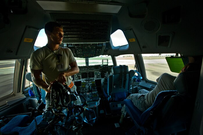 Senior Airman Benjamin Leis, an aircrew flight equipment technician with the 437th Operations Support Squadron out of Joint Base Charleston - Air Base, S.C., swaps out Quick Don oxygen masks on a C-17A Globemaster III, June 8, 2012. The Airmen swap out and inspect equipment for C-17A alert aircraft on standby every 30 days. (U.S. Air Force photo by Airman 1st Class George Goslin/Released)