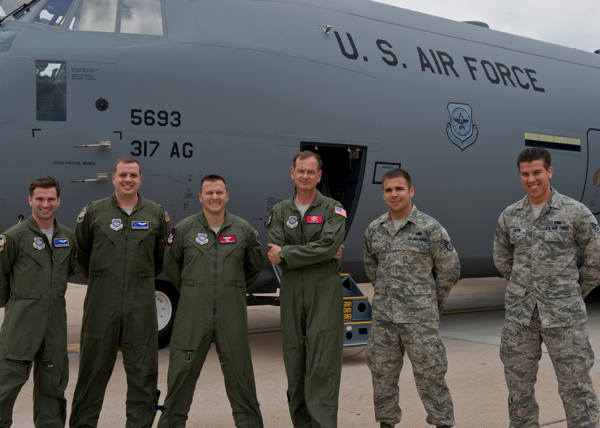The crew of a new C-130 J-model gathers outside the aircraft June 12, 2012, at Dyess Air Force Base, Texas. The aircraft is the 20th of 28 J-models to be delivered to Dyess by 2013, replacing the current legacy fleet of C-130 H-models. (U.S. Air Force photo by Airman 1st Class Jonathan Stefanko/ Released)