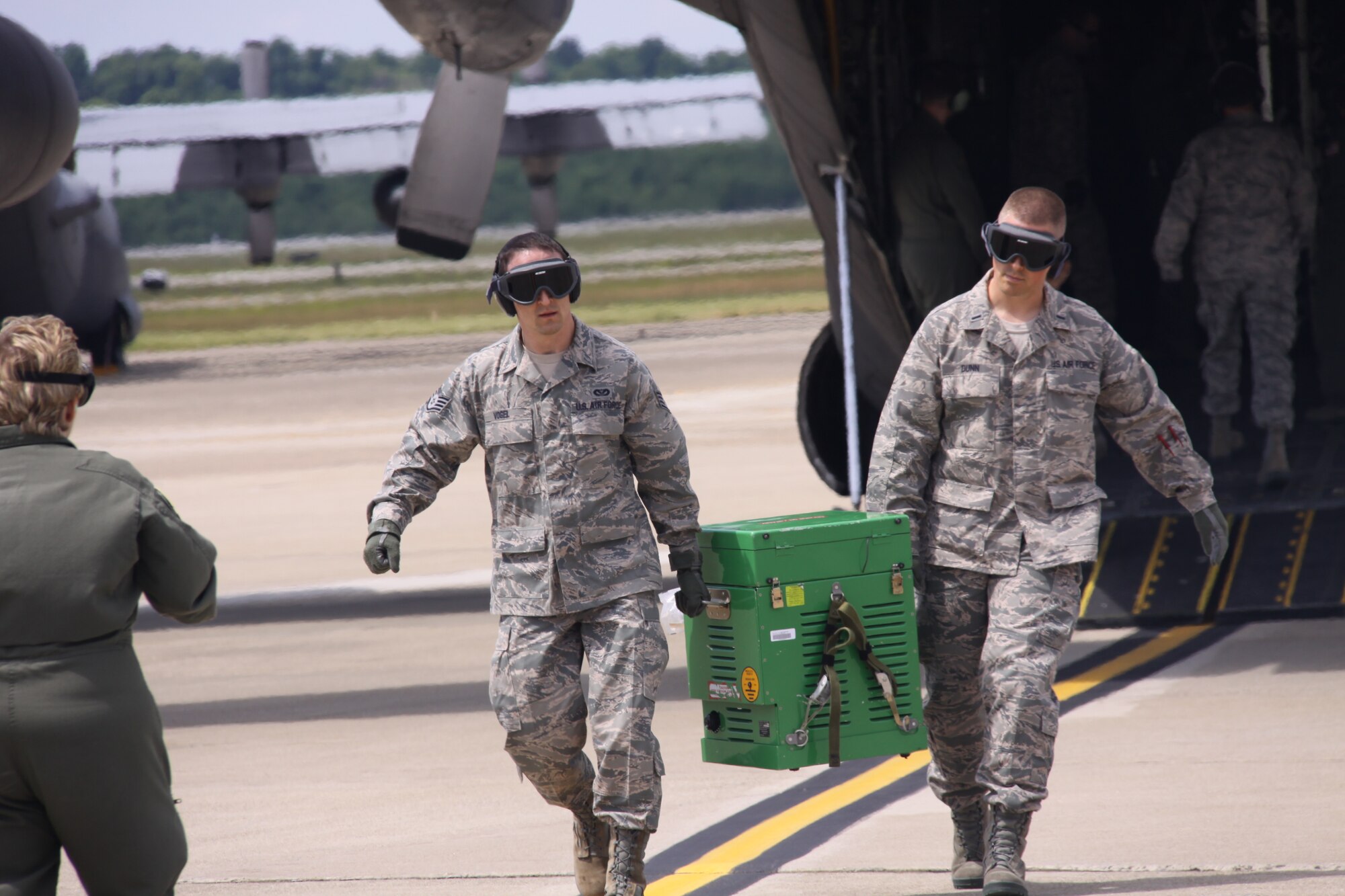Staff Sgt. Derek Vogel and 1st Lt. Andrew Dunn of the 911th Aeromedical Squadron, unload a piece of medical equipment from a C-130 Hercules during an engines running off-load exercise, June 3, 2012. It is important for the AES to practice the procedure because of the noise, fumes, and safety issues that arise when the aircraft’s engines remain running. (U.S. Air Force photo by Senior Airman Jonathan Hehnly/Released)