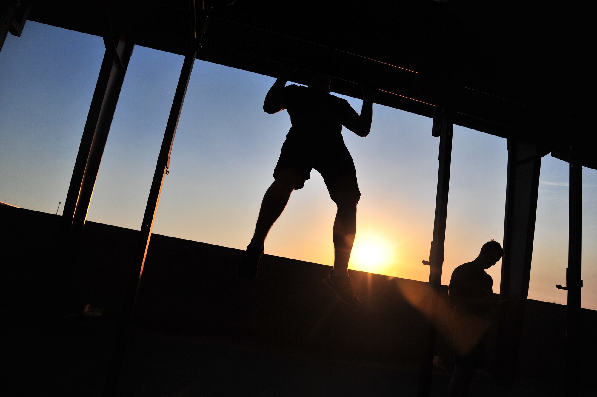U.S. Air Force Airman Basic Eli Gosselin, 27th Special Operations Aircraft Maintenance Squadron communication navigation mission systems apprentice, performs a pull-up during a morning Crossfit session at the combat fitness pad at Cannon Air Force Base, N.M., June 11, 2012. Crossfit establishes broad general fitness versus specialization in one particular area of the body. (U.S. Air Force photo by Airman 1st Class Xavier Lockley)
