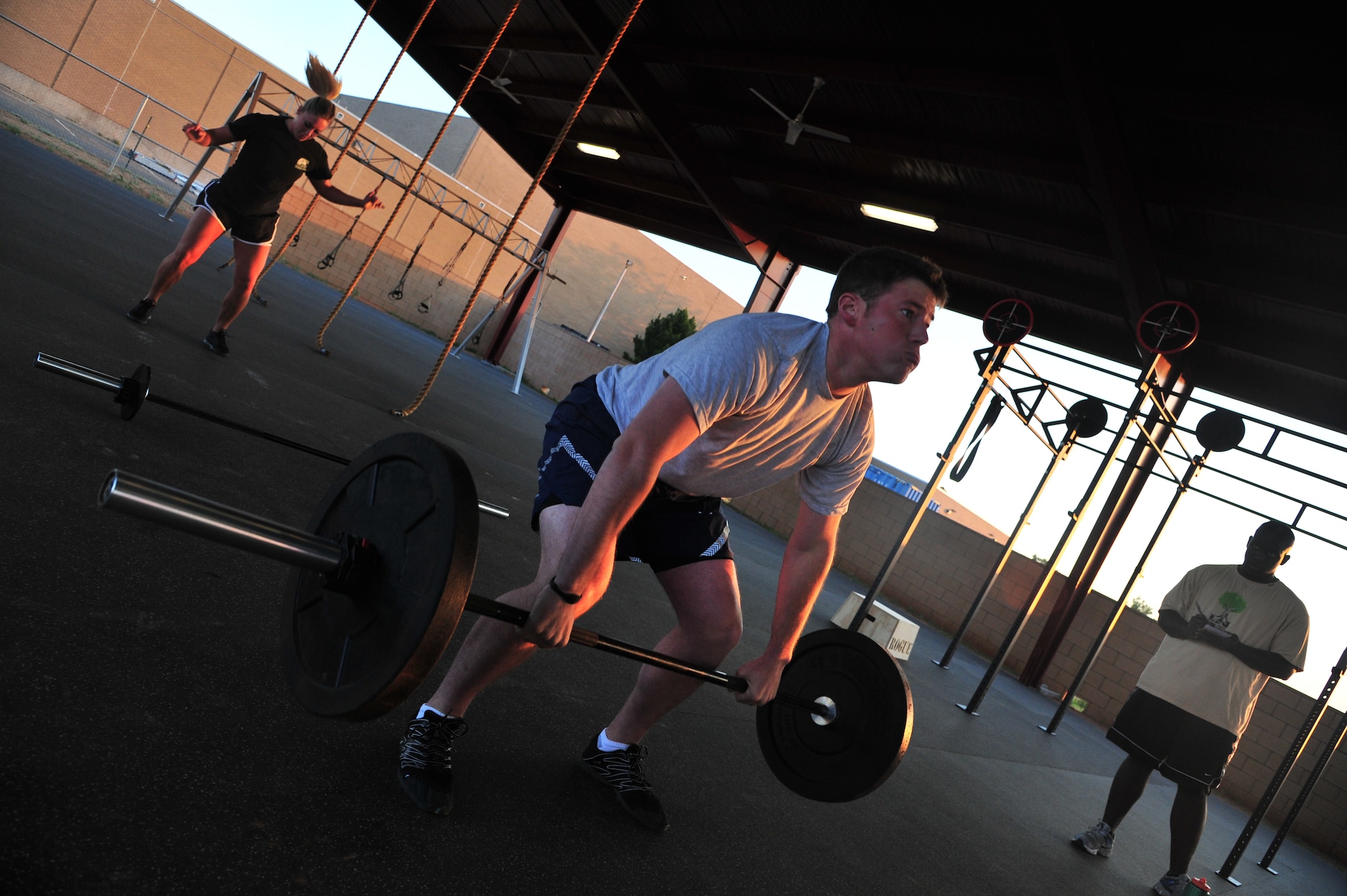 U.S. Air Force 1st Lt. Carter Kunz, 27th Special Operations Civil Engineer Squadron officer in charge of asset optimization, performs the thruster, an exercise that is a combination of a front squat and an overhead press, during a morning crossfit session at the combat fitness pad at Cannon Air Force Base, N.M., June 11, 2012. Crossfit establishes broad general fitness versus specialization in one certain area of the body. (U.S. Air Force photo by Airman 1st Class Xavier Lockley)