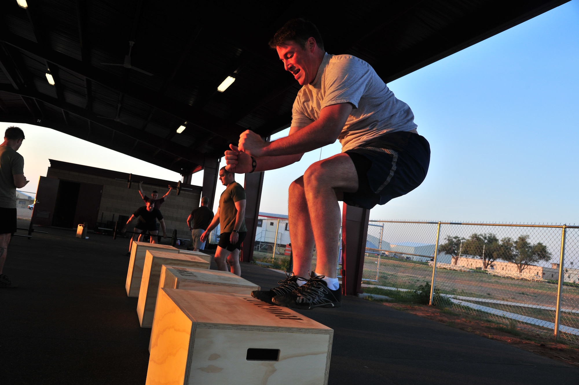 U.S. Air Force 1st Lt. Carter Kunz, 27th Special Operations Civil Engineer Squadron officer in charge of asset optimization, performs the box jump exercise during a morning Crossfit session at the combat fitness pad at Cannon Air Force Base, N.M., June 11, 2012. Crossfit establishes broad general fitness versus specialization in one particular area of the body. (U.S. Air Force photo by Airman 1st Class Xavier Lockley)