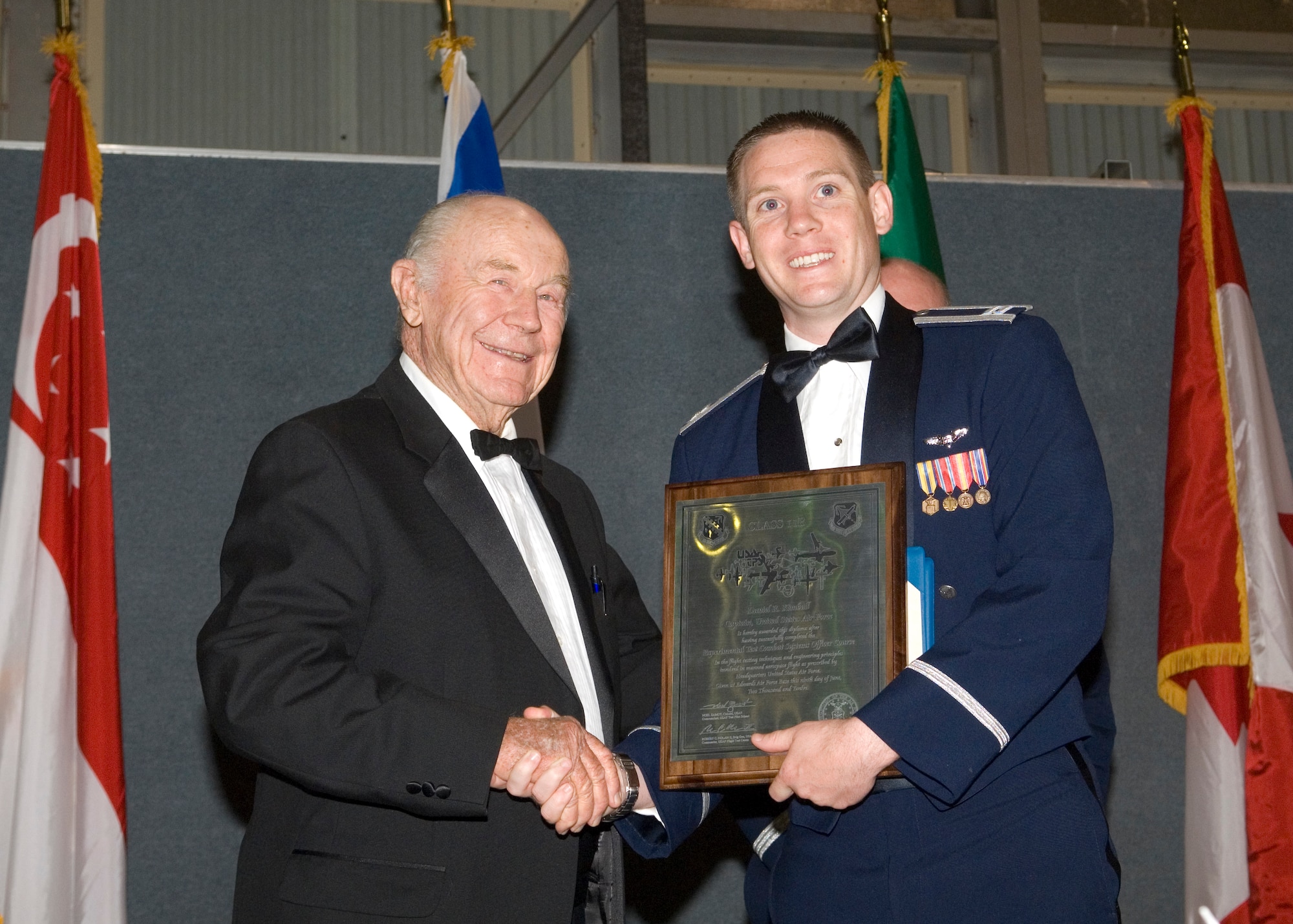 Retired Brig. Gen. Chuck Yeager poses for a photo with United States Air Force Test Pilot School graudate Capt. Daniel Kimball after he received his Master of Science degree in Flight Test Engineering June 9. As guest speaker, Yeager welcomed the TPS graduates to the flight test community. (Air Force Photo by Edward Cannon)